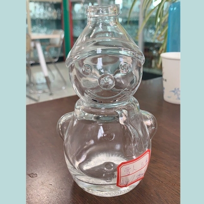 Bouteille de whisky en forme de bonhomme de neige transparente en verre de flint avec une surface décalée